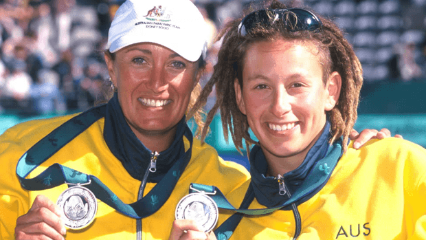Two athletes holding medals.