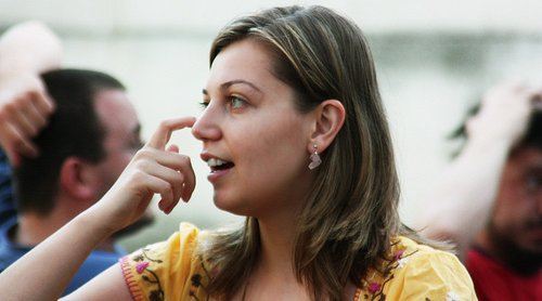 A woman scratching her nose