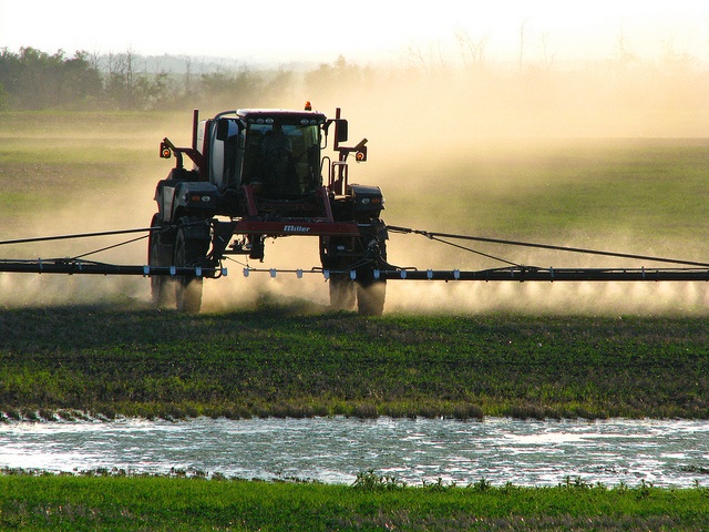 A truck spraying herbicides in a field.