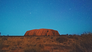 Uluru with stars above