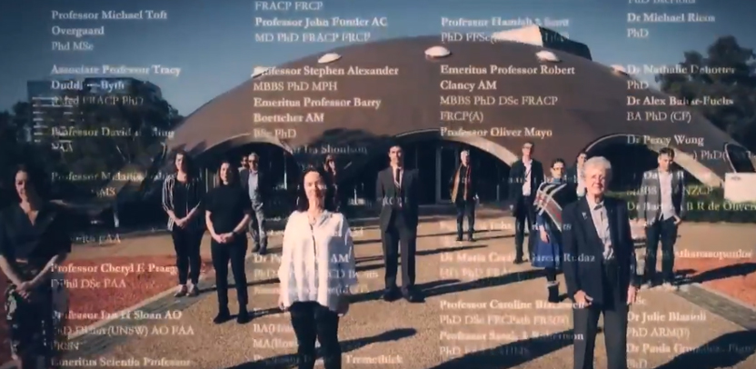 Men and women scientists standing solemnly in front of the Shine Dome, with the names of petition signatories overlaid on the image.