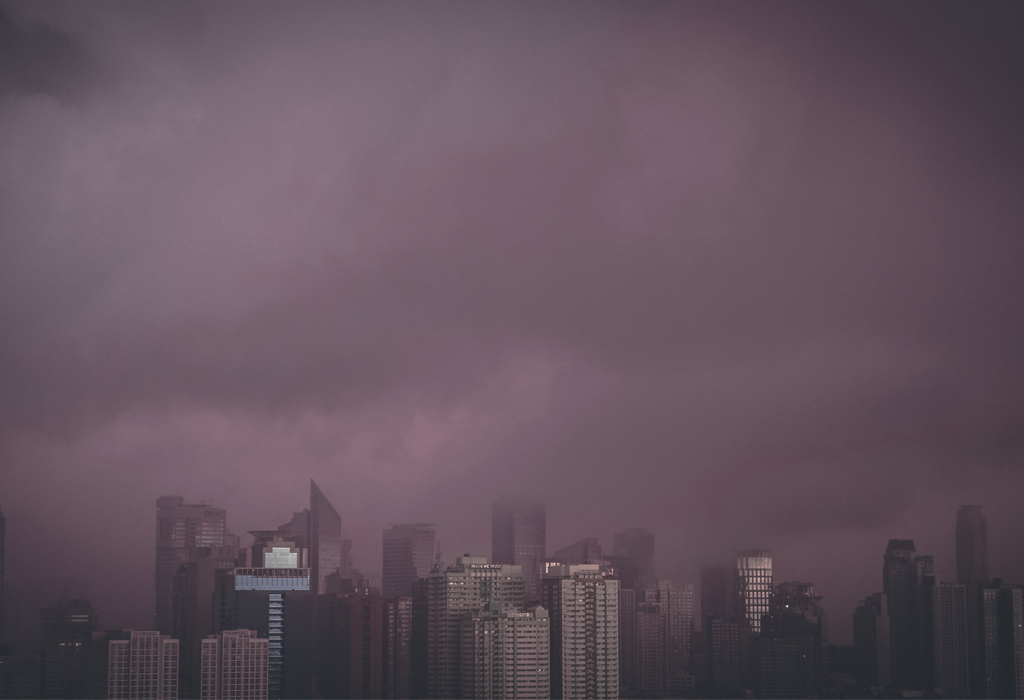 Dark grey smog hanging over high-rise buildings