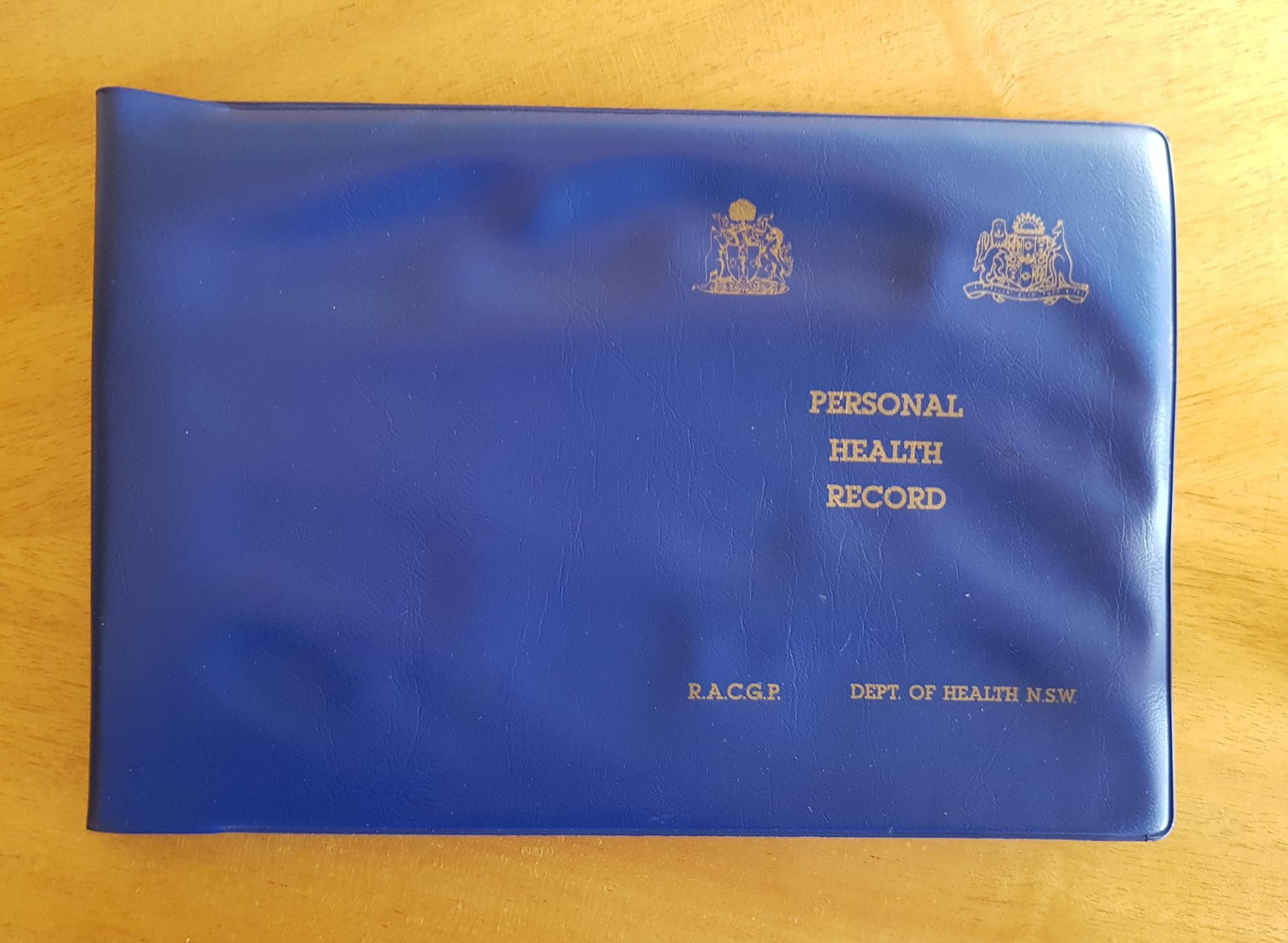 A blue book with Australian Government emblems and the words ‘Personal Health Record’