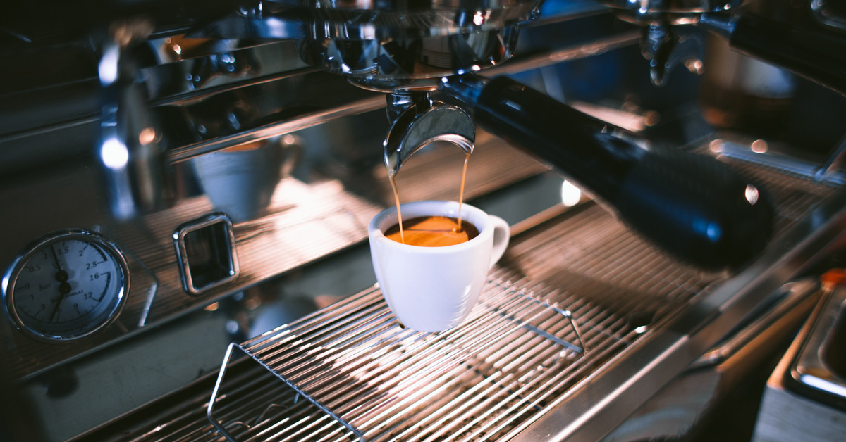 A cup of coffee being made using an espresso machine