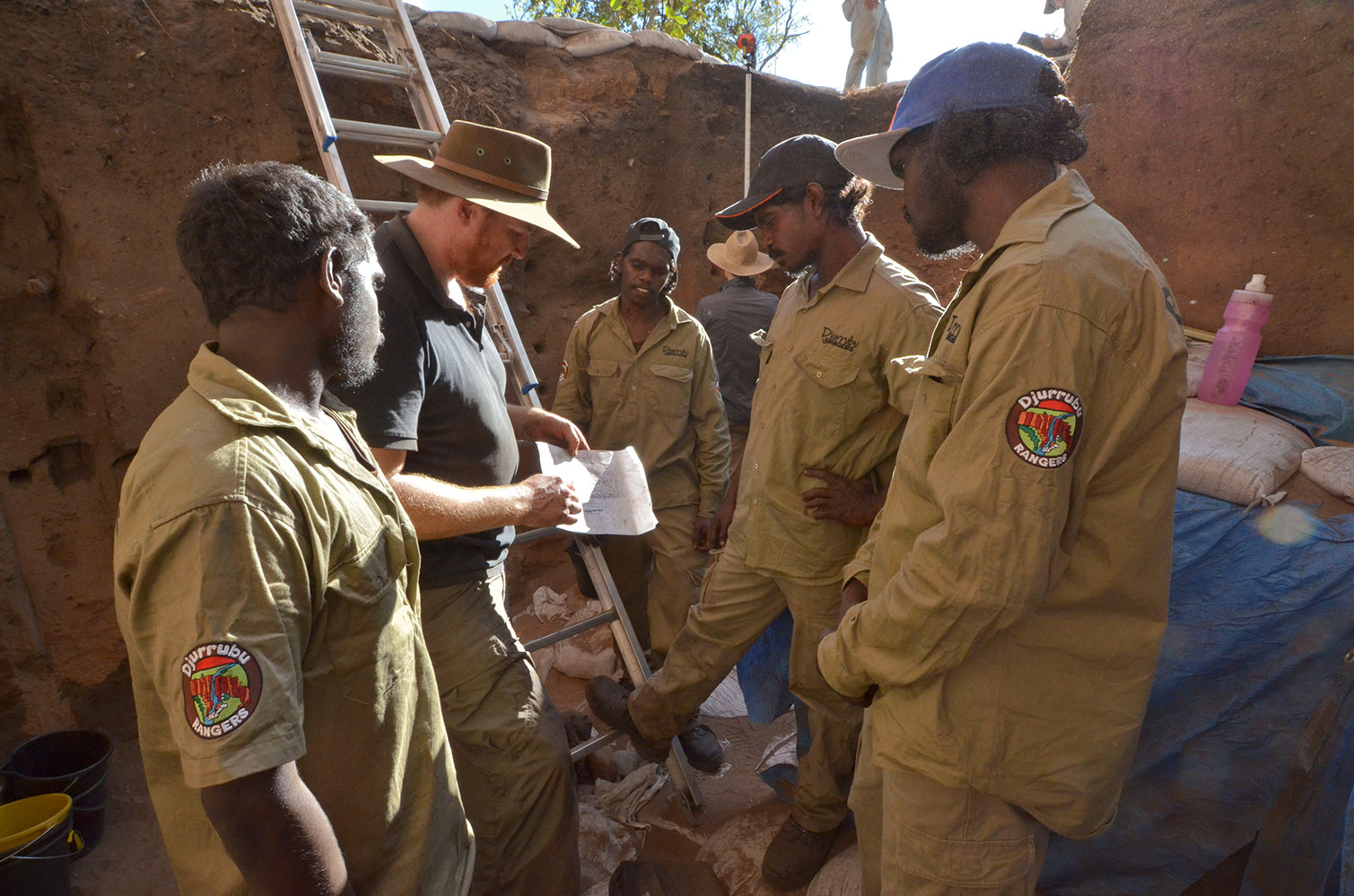 Excavation team standing in the dig site