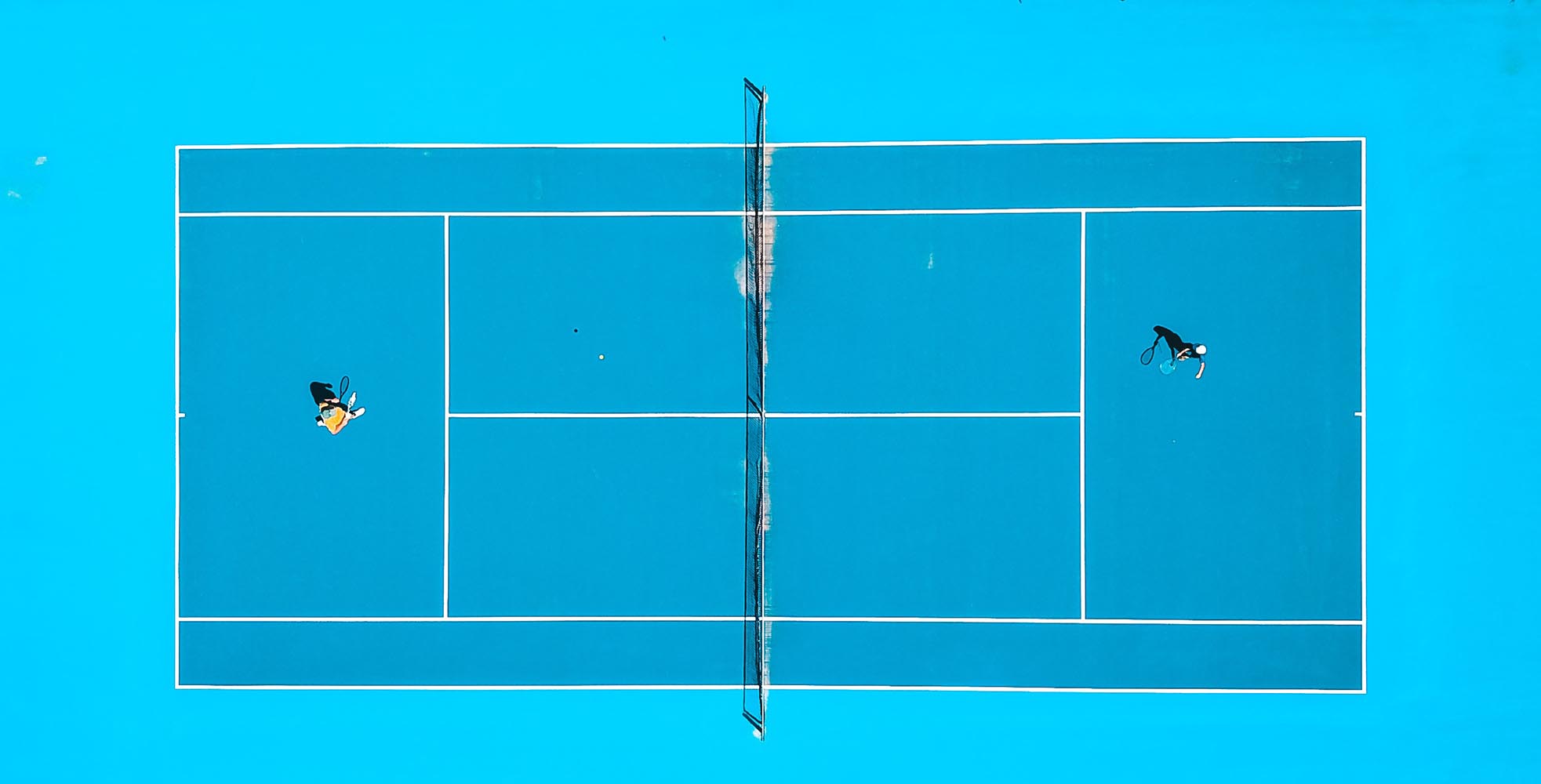 Overhead view of players on a tennis court