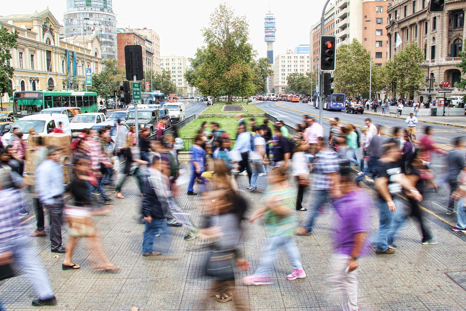 A blurry image of many people walking across the road