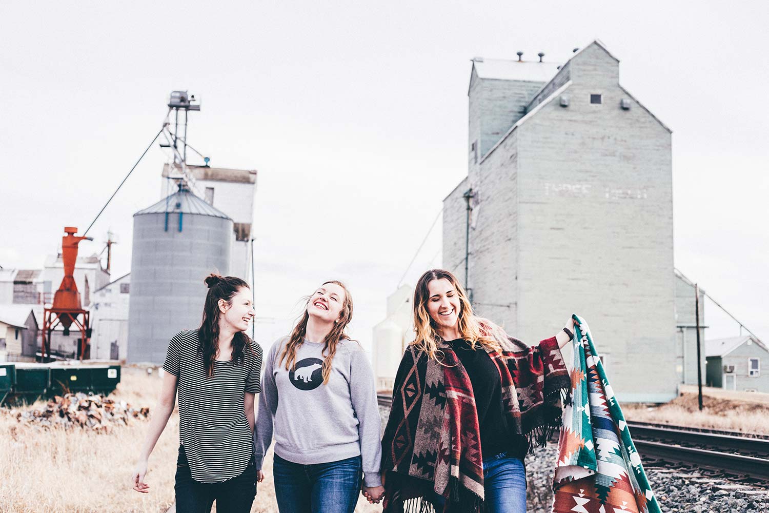 Three young women walking in an industrial setting