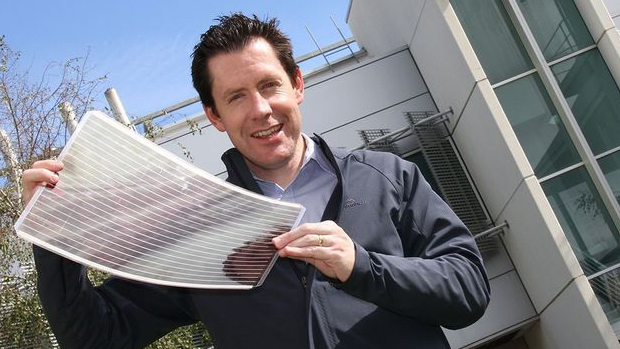 Man holding an A3-sized flexible solar cell.