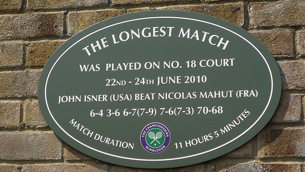 A plaque that reads: the longest match was played on no. 18 court, 22nd-24th June 2010, John Isner (USA) beat Nicolas Mahut (FRA), 6-4 3-6 6-7(7-9) 7-6(7-3) 70-68, match duration 11 hours 5 minutes.