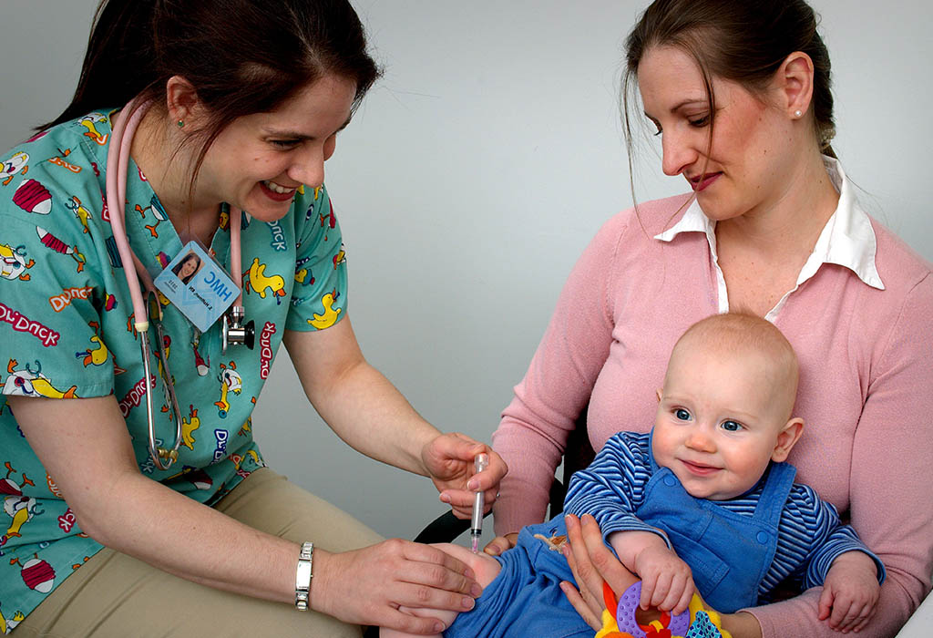 An infant receiving a vaccine from a doctor