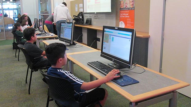 Children learning to code at a public library.