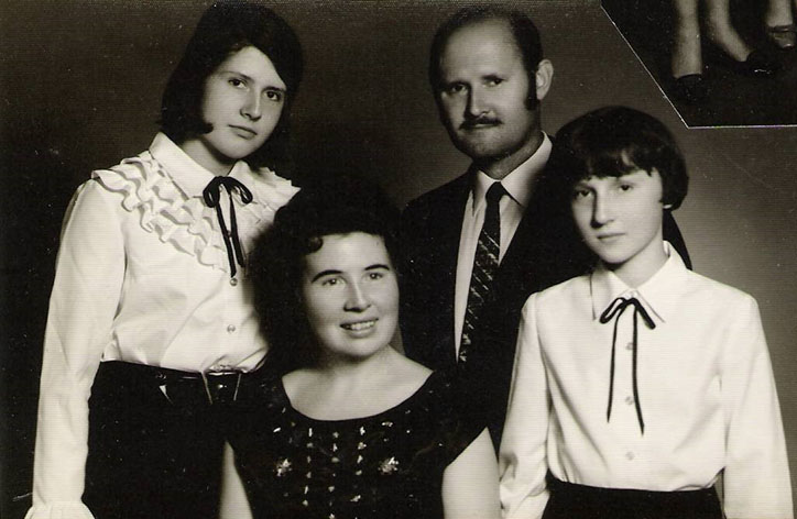 Black and white photo of a man, woman, and two teenage girls