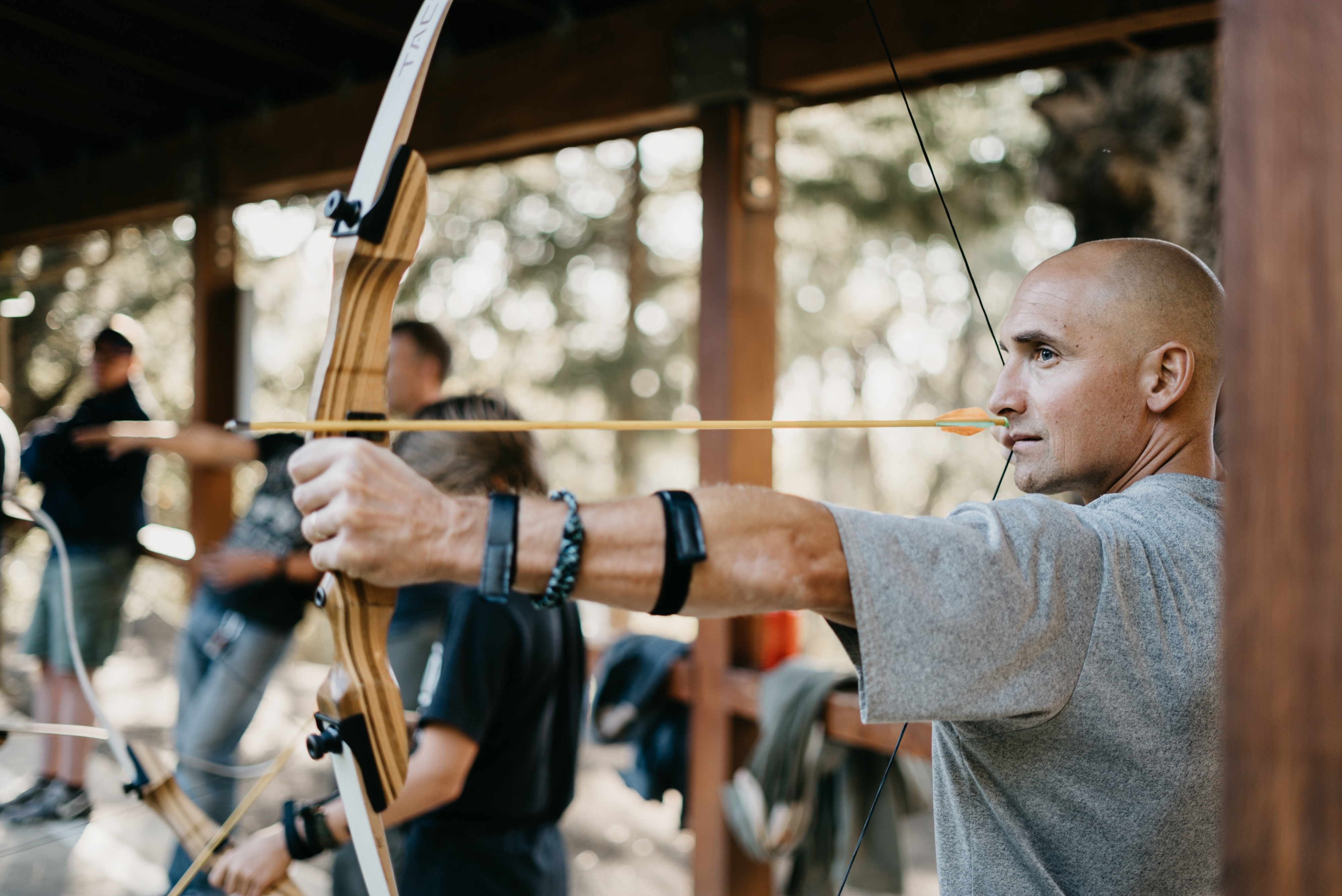 Close up of a person about to fire an archery arrow