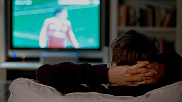 Man watching sport on TV.