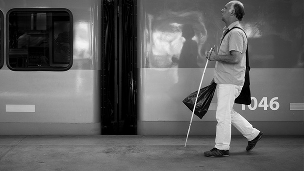A man walking with a white cane
