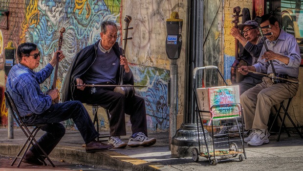 Four elderly men playing musical instruments