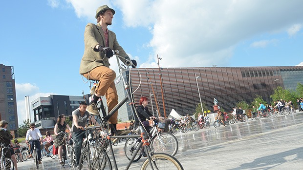 A man on an unusual bicycle