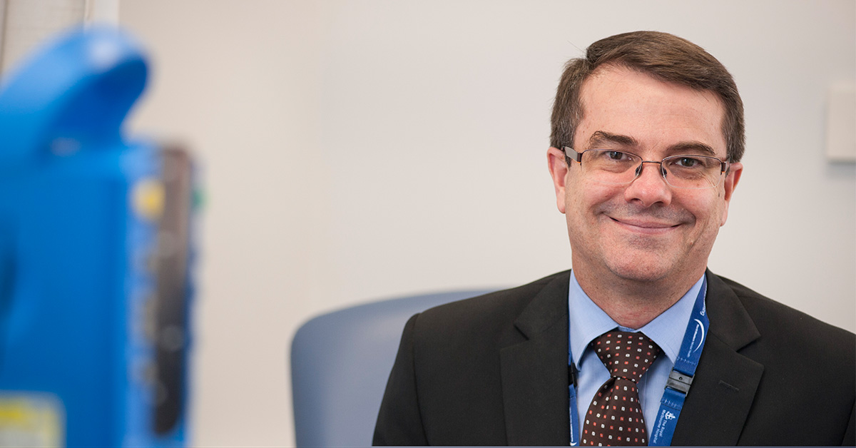 Professor Andrew Roberts headshot in a clinic