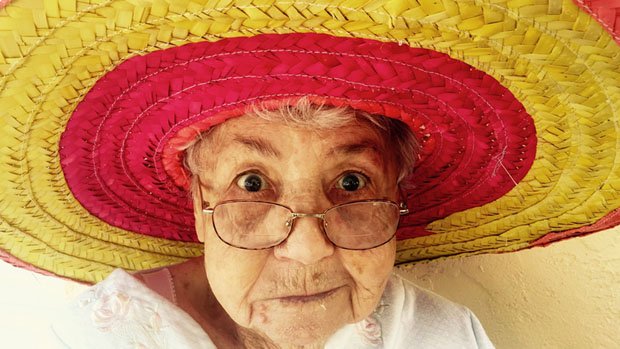 Old woman wearing a colourful sombrero.