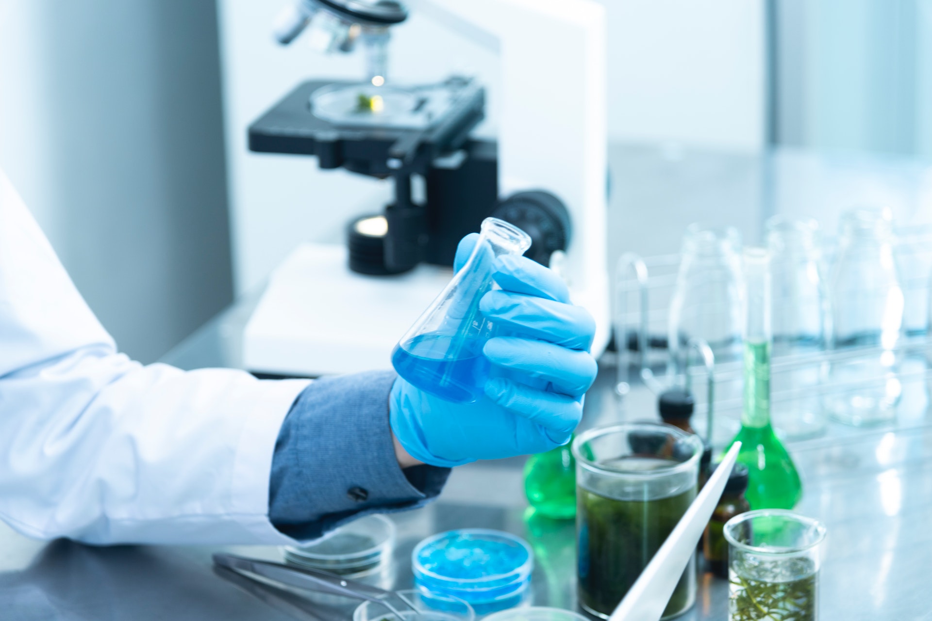 A person holding a laboratory flask