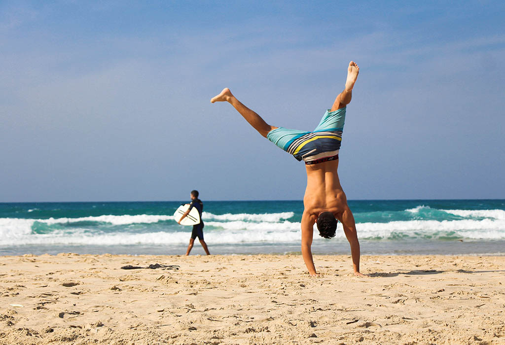 Someone doing a cartwheel on a beach