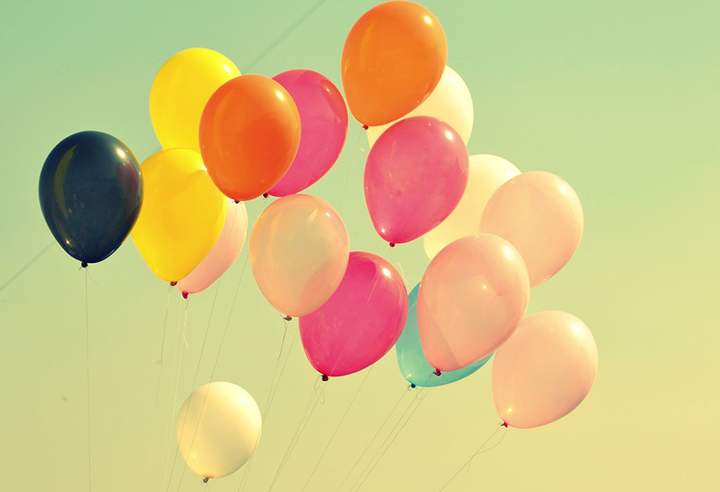 Colourful balloons lifting into the sky