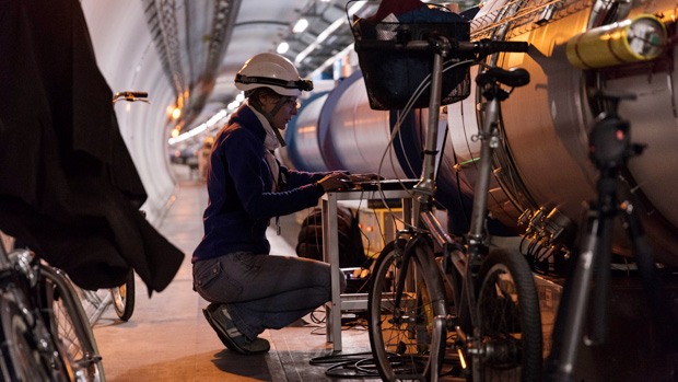 A technician inspecting the Large Hadron Collider through a computer interface.