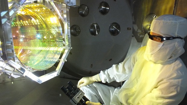 An optics technician inspecting LIGO for contaminants
