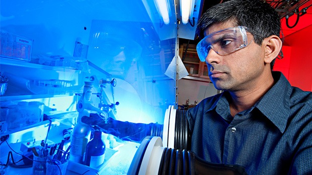 A researcher working on the fabrication and assembly of lithium-battery cells.