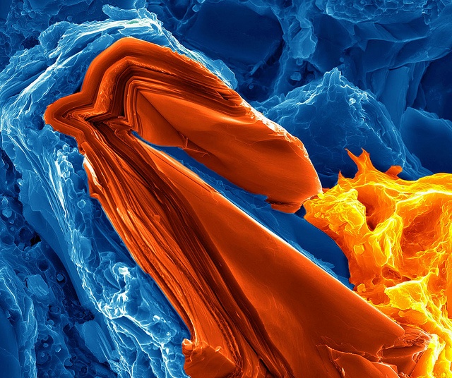 An electron microscope image, in false colour, of a magnesium matrix composite reinforced with titanium aluminium carbide.