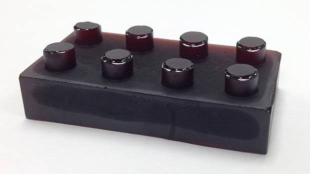 A moulded block of mercury bonding polymer in the shape of a LEGO brick