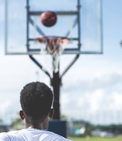 A man slam dunking a basketball.