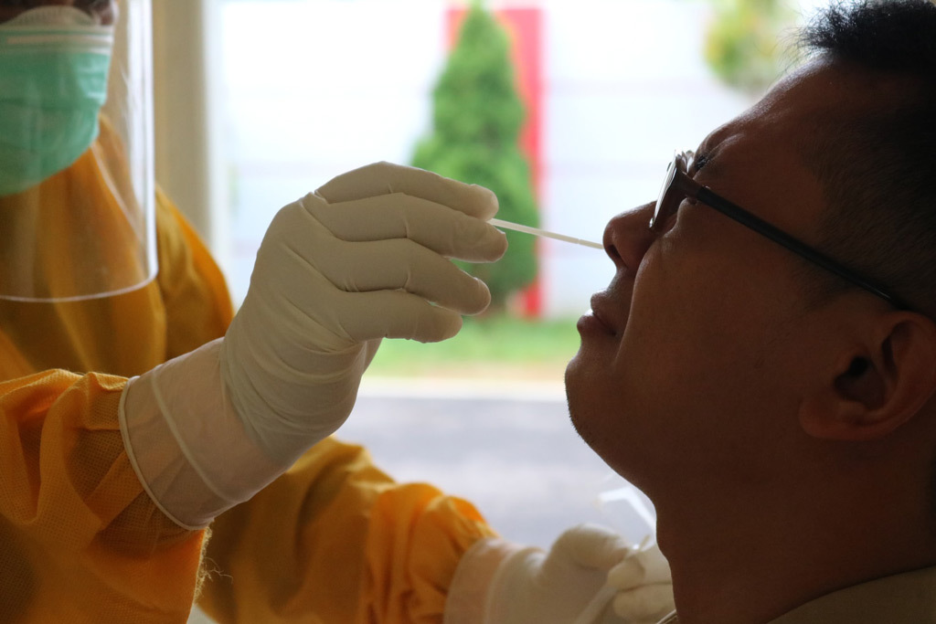 A person receiving a nasal swab test for COVID-19.