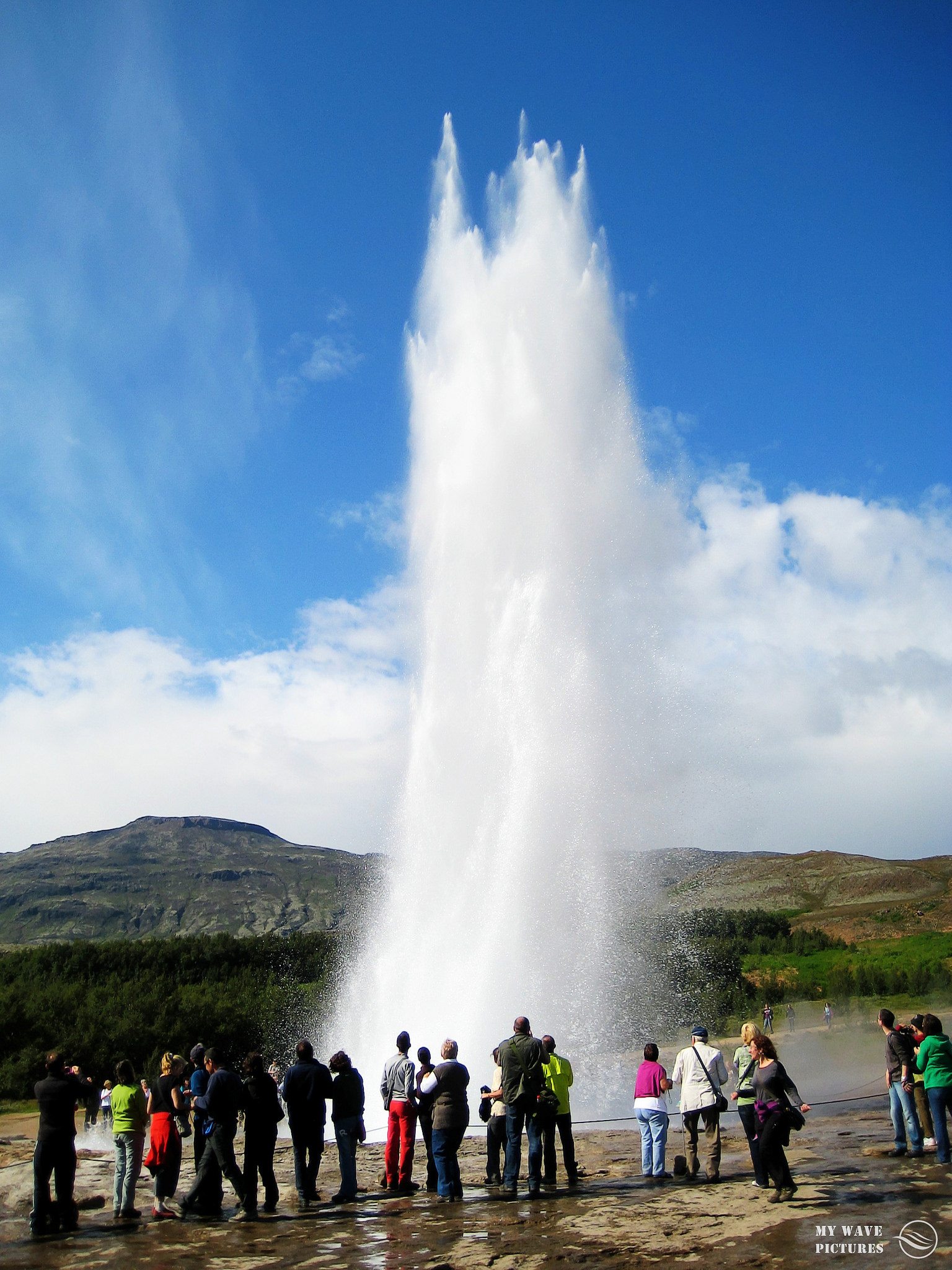 People view the Strokker geyer erupting in Iceland. 