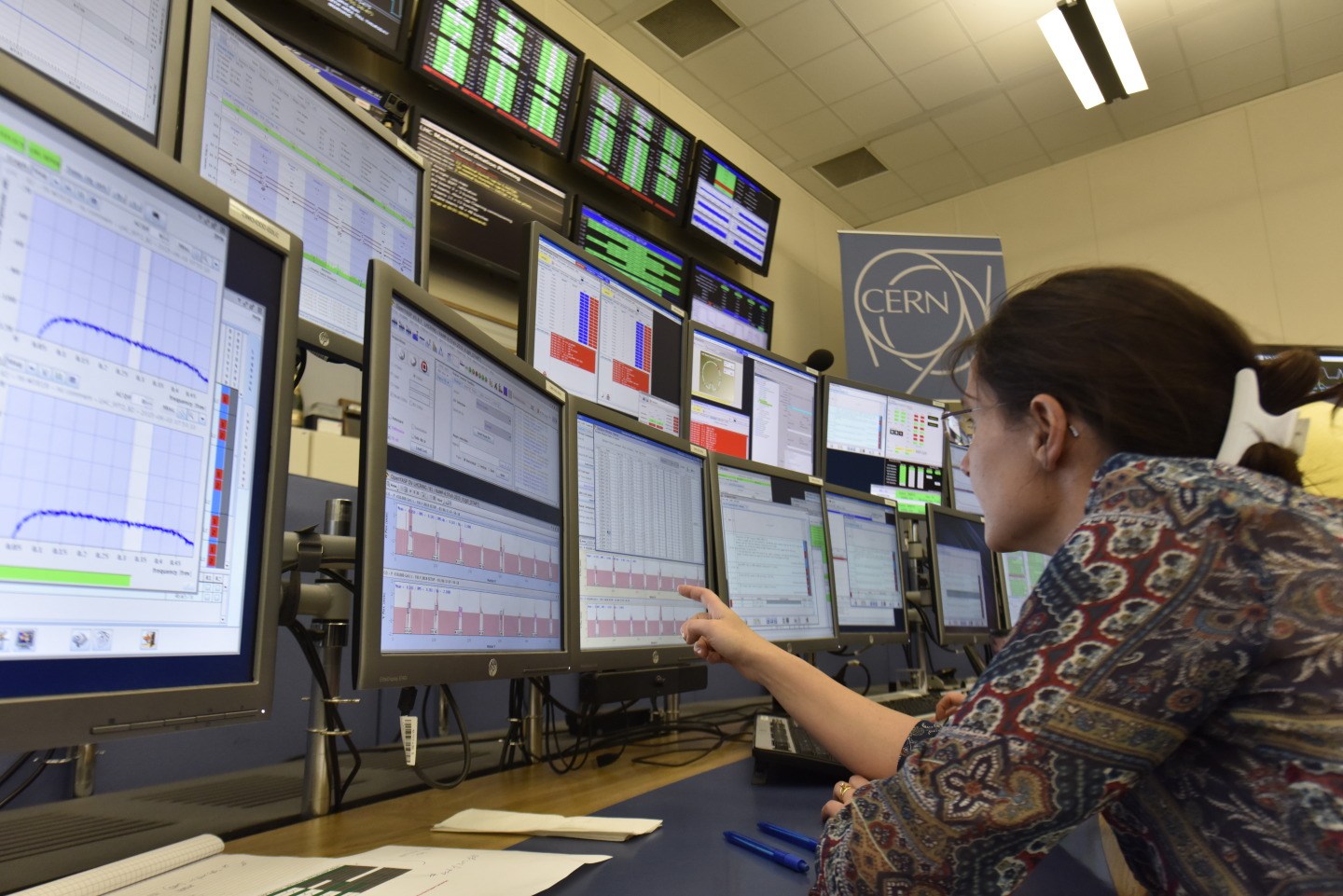One of the LHC operators analyses the many screens of data that physicists use to monitor and operate the machine.