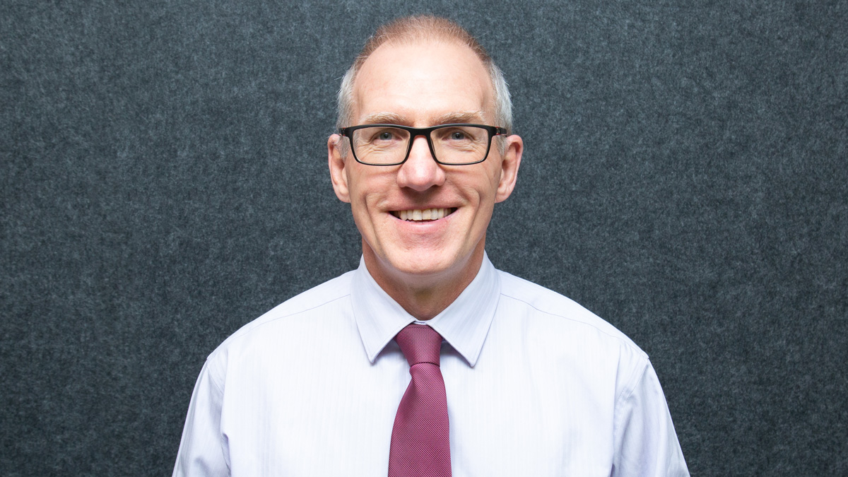 a portrait of a man wearing a white shirt and red tie