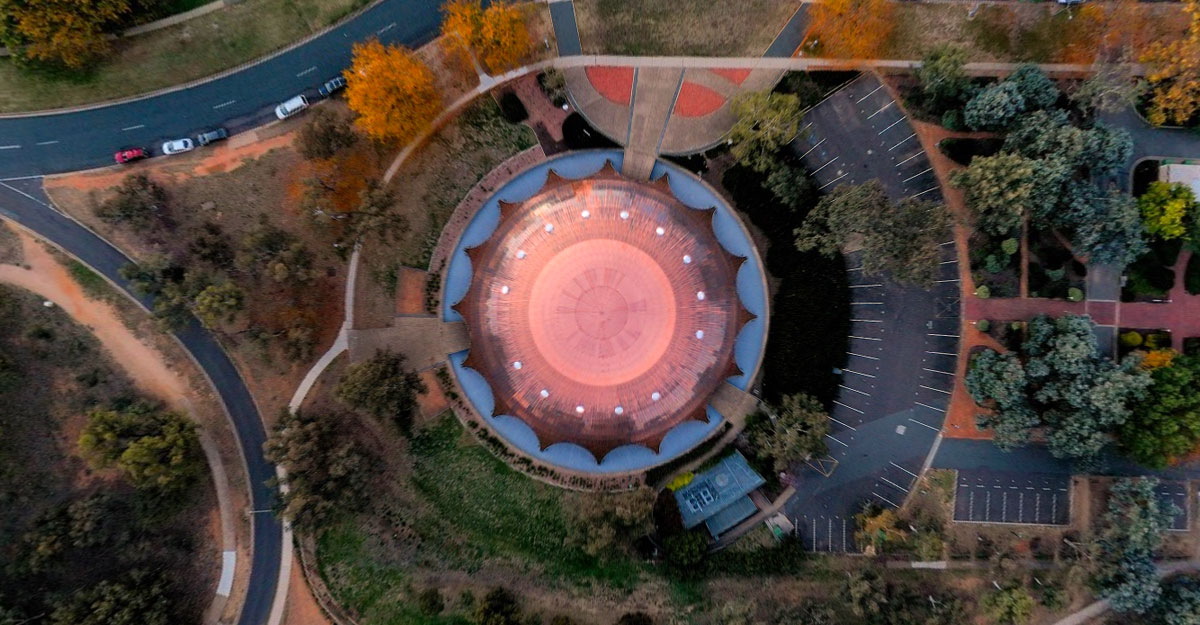 The Shine Dome from the air, showing circular shape and nearby landscape of roads, grass and trees