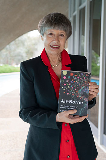 Professor Lidia Morawska holding a copy of the book 'Air-borne'