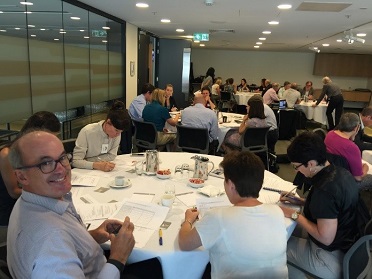 Groups of participants at the Future Earth workshop sitting at tables