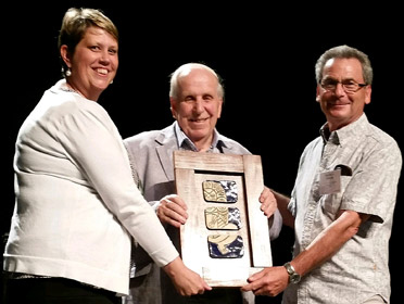 photo of Professor Short receiving a framed award