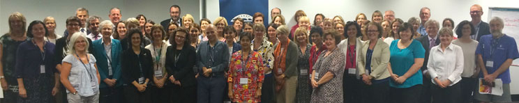 Large group of people, smiling at camera