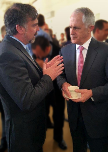 Rod Bender and Malcolm Turnbull  talking over coffee, with people in the background