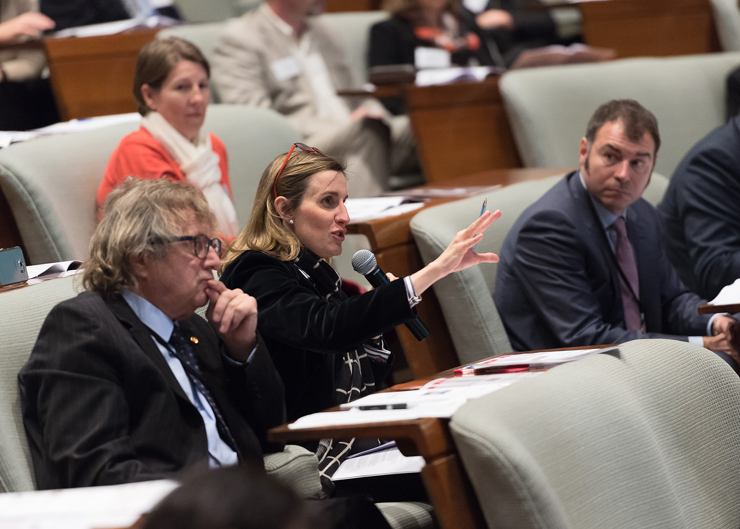 An audience member asks a question of one of the presenters