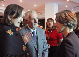 Two women and a man in animated conversation