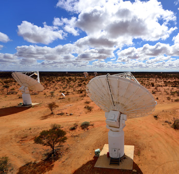 Two large radio telescopes in an arid landscape