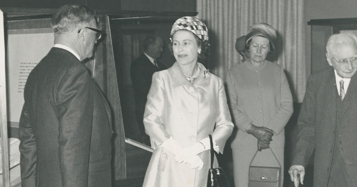 A young Queen Elizabeth talks to a man in a suit