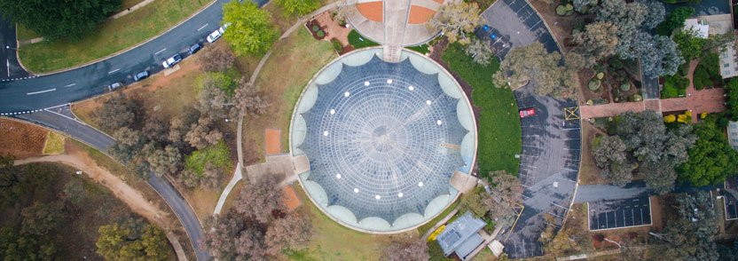 The Shine Dome from the air, showing circular shape and nearby landscape of roads, grass and trees