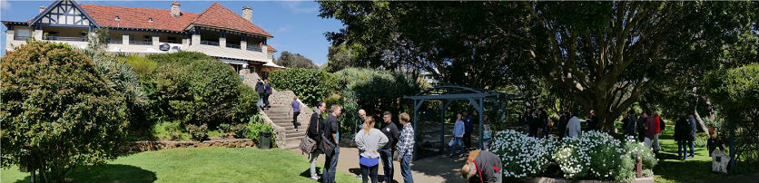 People walking in gardens of historic house