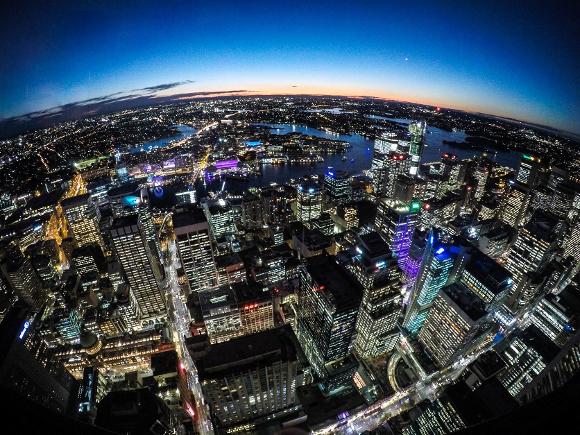 Sydney city lights at night with curved horizon, hinting at a planet